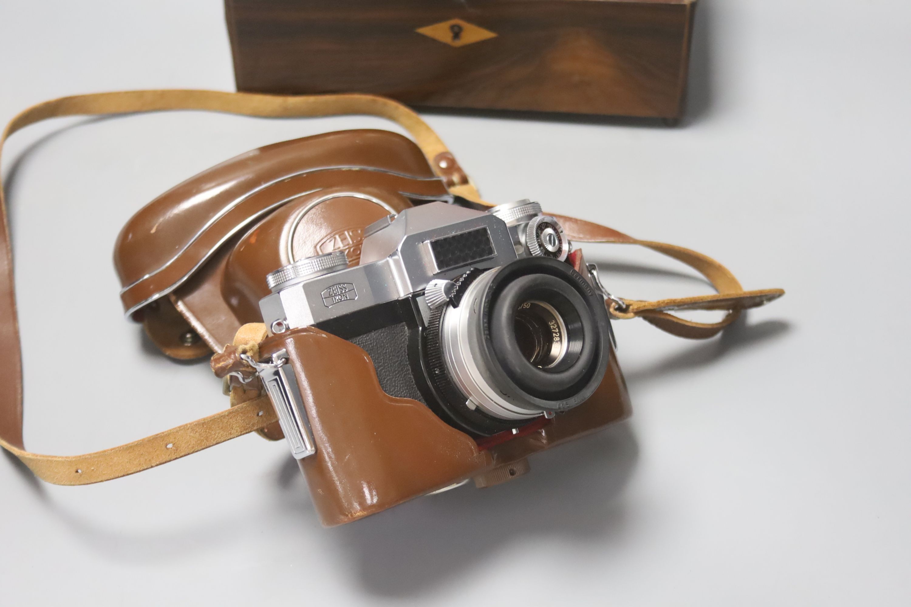 A French rosewood tea caddy, a tortoishell box, a camera and another box